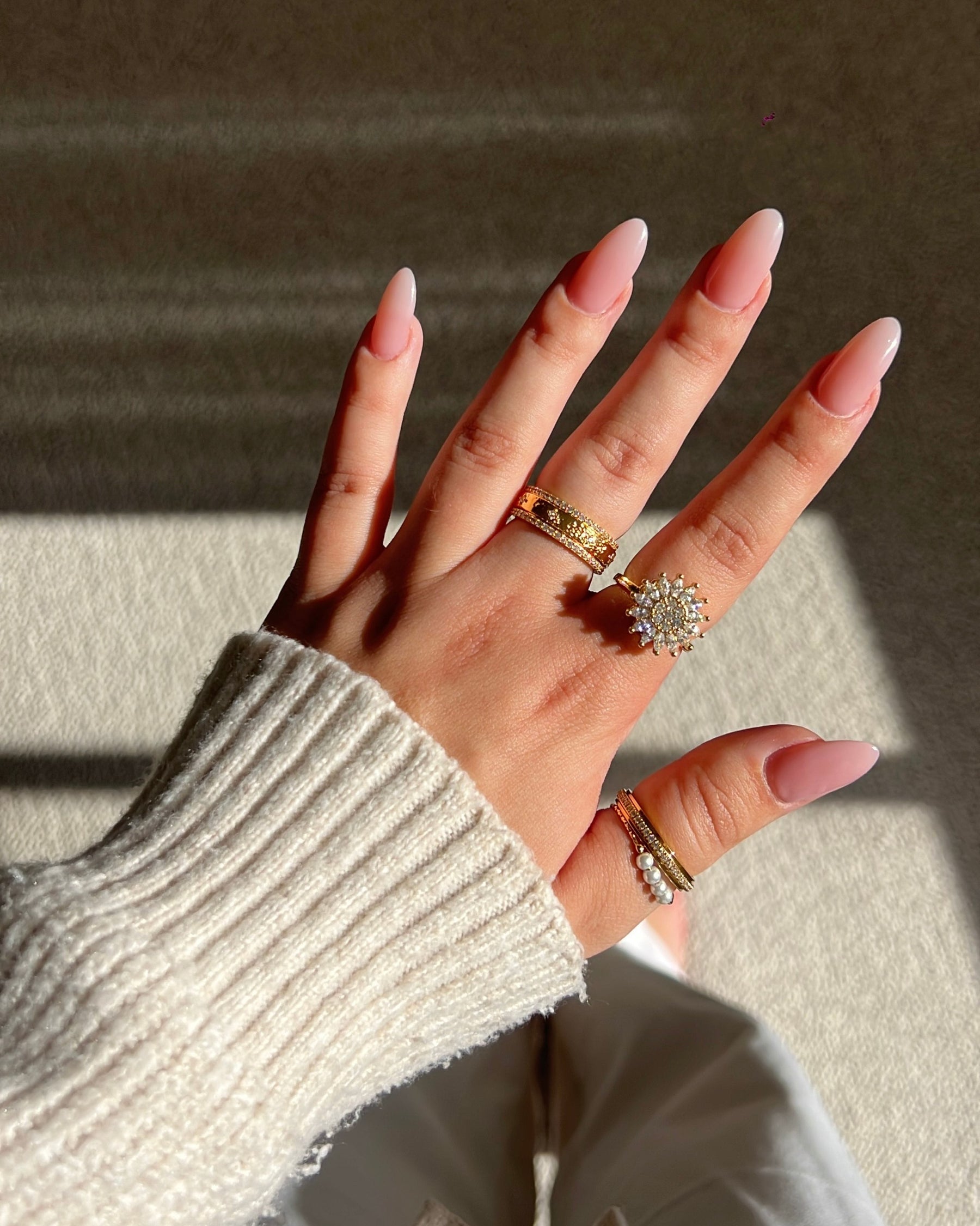 A hand wearing a selection of Worry Rings